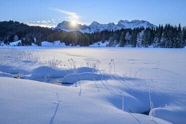 Deutschland, Bayern, Sonnenaufgang über schneebedecktem See in den bayerischen Alpen - ANSF00251
