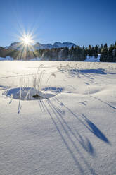Germany, Bavaria, Sun rising over snow-covered lake in Bavarian Alps - ANSF00253