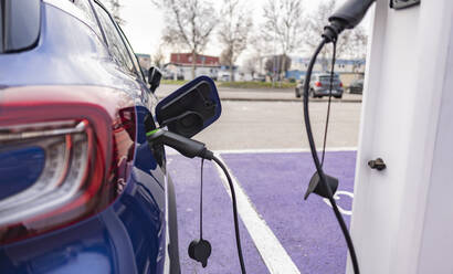 Car refueling at electric vehicle charging station - JCCMF09244