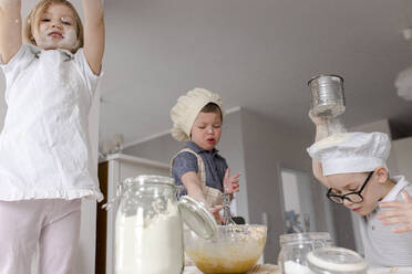 Girl with brother preparing dough in kitchen - VIVF00402