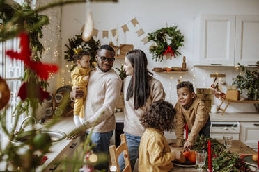 Glückliche Eltern, die zu Weihnachten Zeit mit ihrem Sohn und ihren Töchtern in der Küche verbringen - MDOF00582