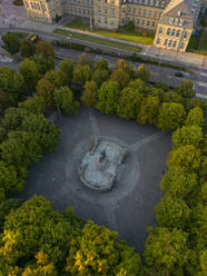 Drone view of King Karl's memorial statue amidst trees, Stuttgart, Germany - TAMF03911