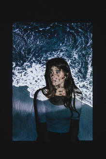 Projection of sea wave on contemplative young woman - MRAF00912