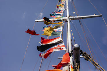 Multi colored national flags on yacht mast - OSF01367