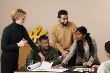 Multiracial fashion designers working together in studio - RSKF00050