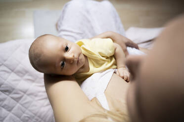 Baby boy lying in mother's arm - NJAF00224