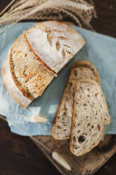Freshly baked sourdough bread on napkin - ONAF00392
