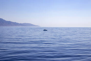 Spain, Balearic Islands, Lone boat in Mediterranean Sea - KSWF02273