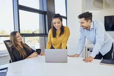 Business colleagues discussing together in meeting at workplace - BSZF02079