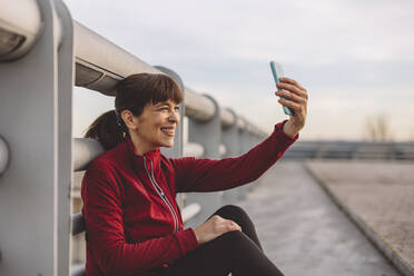 Glückliche reife Frau nimmt Selfie obwohl Smartphone - JCCMF09386