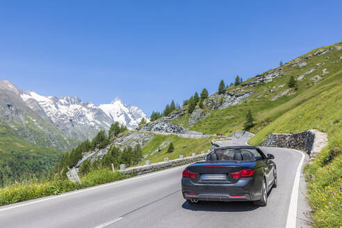 Austria, Salzburg, Sports car driving along Grossglockner High Alpine Road in summer - FOF13420