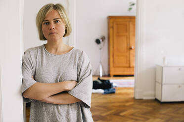 Serious portrait of woman standing in home - MASF34765
