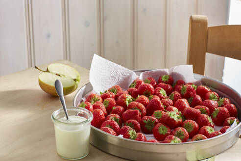 Fresh ripe strawberries and jar of yogurt - KSWF02275