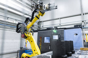 Robotic arm with machinery in factory - AAZF00030