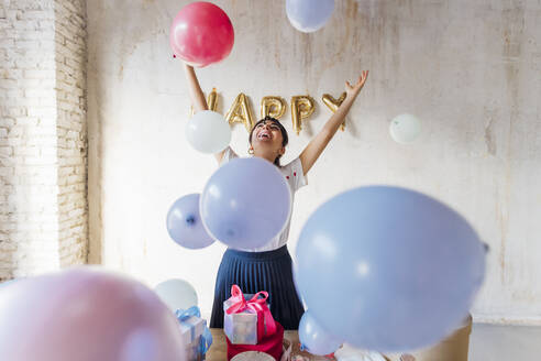 Happy woman enjoying with balloons - MEUF08912