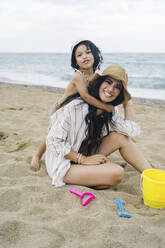 Mother and son having fun at beach - JJF00050