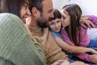 Happy family spending time together on sofa at home - WPEF07267