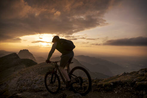 Mountain biker riding on slope at mountain - MALF00425