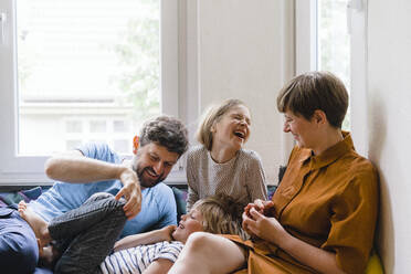 Happy family enjoying together sitting at home - JOSEF17014