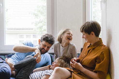 Happy family enjoying together sitting at home - JOSEF17014