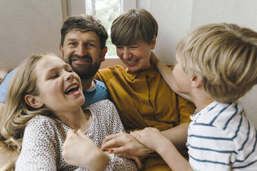 Cheerful woman having fun with family at home - JOSEF17143