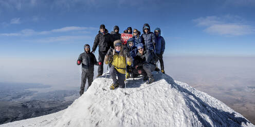 Hikers friends on snowcapped mountain in front of sky at sunny day - ALRF02003