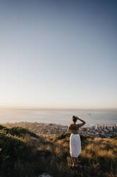 Woman looking at city from Signal Hill on weekend - LHPF01483