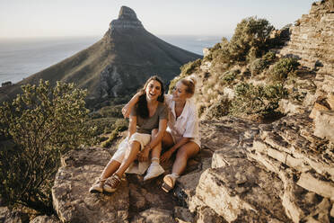 Friends enjoying sunset sitting on rock of Signal Hill - LHPF01489