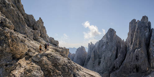 Man and women hiking on sunny day at Mont Mulaz, Dolomites, Italy - ALRF02071