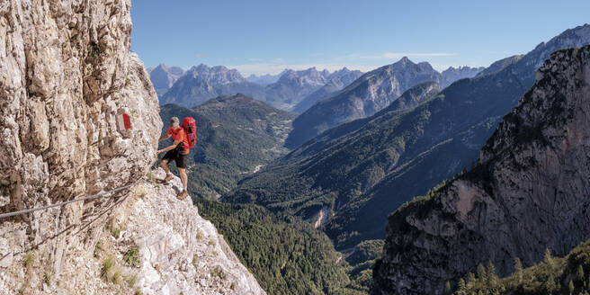 Man rock climbing on sunny day at Dolomiti Bellunesi National Park,Forcella Comedon, Dolomites, Italy - ALRF02084