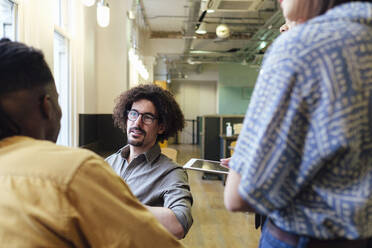 Businessman conducting meeting with colleagues at office - ASGF03322