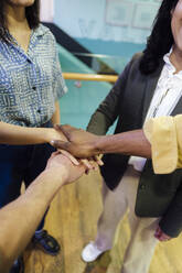 Geschäftskollegen stapeln die Hände bei einem Treffen im Büro - ASGF03330