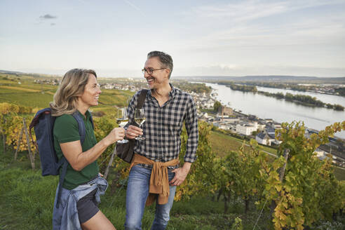 Glückliches reifes Paar genießt Wein auf einem Hügel - RORF03373