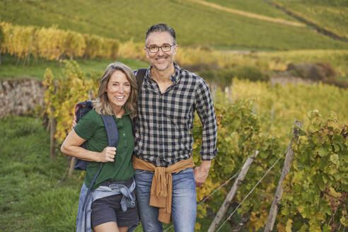 Happy mature tourists standing together on hill - RORF03381