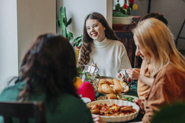 Happy family having Easter dinner together at home - VSNF00449