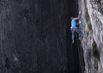 Man with harness climbing rocky mountain - ALRF02091