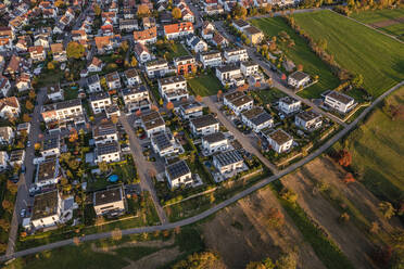 Germany, Baden-Wurttemberg, Baltmannsweiler, Aerial view of modern suburb at autumn dusk - WDF07253