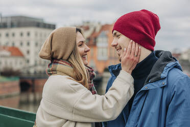 Romantic woman touching boyfriend's face - VSNF00513
