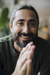 Smiling mature man with beard in cafe - JOSEF17177