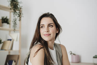 Contemplative businesswoman sitting in office - EBBF08043