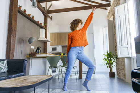 Woman with curly hair dancing at home - JSMF02669