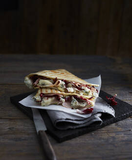 Studio shot of ready-to-eat piadina romagnola flatbread sandwich - KSWF02303