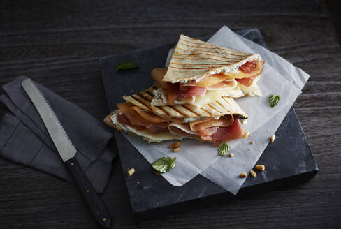 Studio shot of two ready-to-eat piadina romagnola flatbread sandwiches - KSWF02304