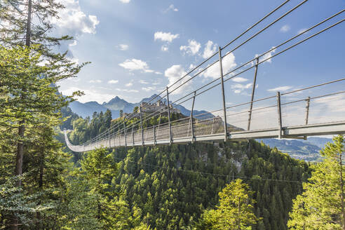 Austria, Tyrol, Reutte, Suspension bridge spanning against Ehrenberg Castle - AIF00773