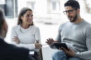 Businessman explaining strategy to colleagues at workplace - JSRF02416