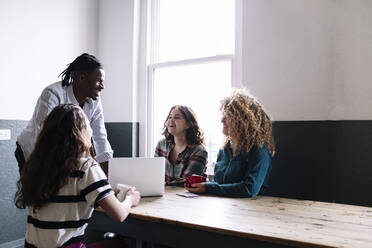 Happy business people discussing in meeting at coworking office - AMWF01143