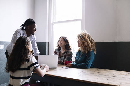 Fröhliche Geschäftsleute diskutieren bei einem Treffen im Coworking-Büro - AMWF01143