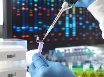 Scientist pouring DNA sample through pipette in test tube - ABRF01054