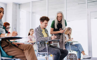 Universitätsstudenten mit einem Lehrer, die drinnen lernen, Unterricht im Klassenzimmer. - HPIF06182