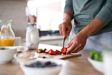 Midsection von unerkennbaren Mann bereitet Smoothie drinnen zu Hause, gesunde Ernährung Konzept. - HPIF06253